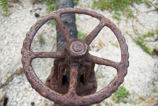 Weathered cast iron hand wheel on gate valve