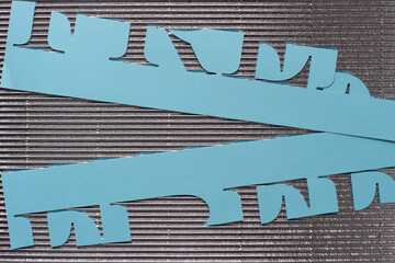 cut paper stencil with the word 