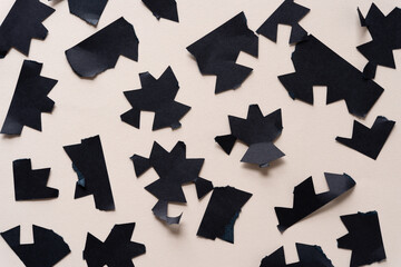 torn paper shapes on beige
