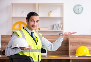 Young male architect working in the office