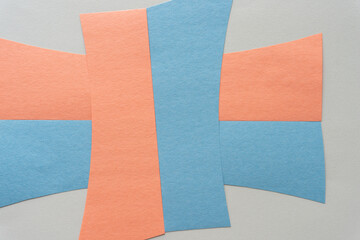 pale orange and blue gray construction paper shapes on a beige background