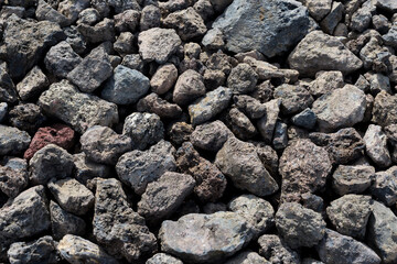 Small black stones of solidified lava close-up
