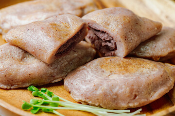 susubukkumi, Korean Pan-fried Millet Rice Cake : or this dish, first make the dough by mixing glutinous sorghum powder with warm water. Next, fry flattened dough balls on a pan, add red bean filling, 