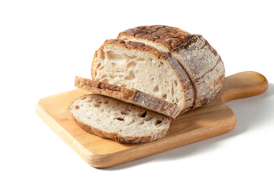 Sliced Sourdough Bread on wood board isolated on white background, homemade bakery
