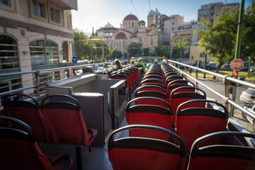 View from open roof of red, turistic hop on bus with tourists inside. Vacation, travel concept
