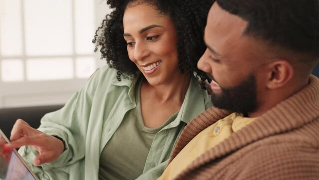 Tablet, love and relax with a black couple doing an online search while sitting on the sofa of their home together. Social media, scrolling and internet with a man and woman relaxing in a living room