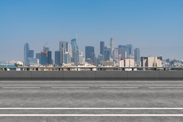 Fototapeta premium Empty urban asphalt road exterior with city buildings background. New modern highway concrete construction. Concept of way to success. Transportation logistic industry fast delivery. Los Angeles. USA.