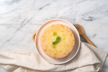 Delicious Lemon Glazed Pound Sponge cake on white marble table background.