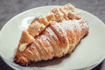 French Pastry on a plate with concrete background. French Croissant, Cinammon Roll, Cruffin, Bread Stick, Scones.