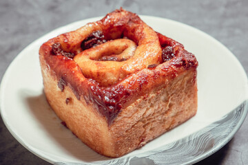 French Pastry on a plate with concrete background. French Croissant, Cinammon Roll, Cruffin, Bread Stick, Scones.