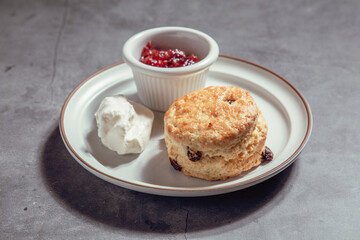 French Pastry on a plate with concrete background. French Croissant, Cinammon Roll, Cruffin, Bread Stick, Scones.