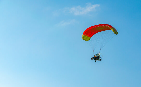 Paraplanners in the air with beautiful blue sky and clouds in the background