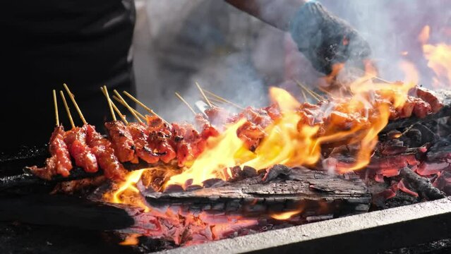 Select focus the burning charcoal of grilled chicken satay which is famous street food