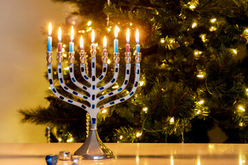 Hanukkah is celebrated with a menorah nine burning candles.