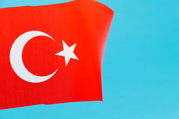 Turkish flag waving on blue background