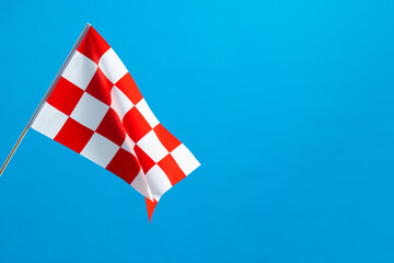 Checkered flag waving on blue background