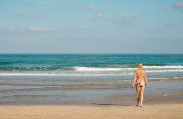 Seascape with a woman entering the water