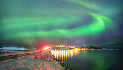 Sommaroy Bridge is a cantilever bridge connecting the islands of Kvaloya and Sommaroy with Aurora Borealis - Hillesoy Tromso Norway