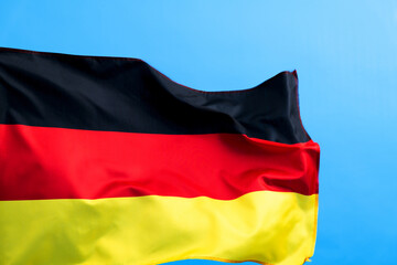 Naklejka premium Germany flag waving on blue background