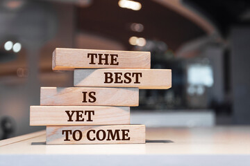 Wooden blocks with words 'The Best is Yet to Come'.