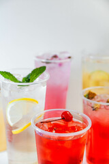 Set of different colors of lemonades and different flavors on a white background and against each other