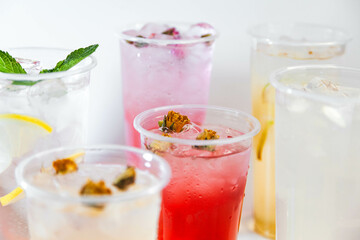 Set of different colors of lemonades and different flavors on a white background and against each other