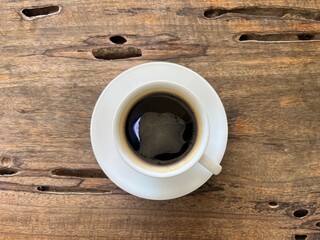 Top view, a cup of hot americano on wooden table 