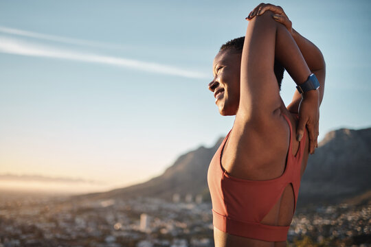 Mountain, fitness and stretching woman with smile for running goals, success or training freedom on blue sky mockup. Muscle wellness of sports black woman or runner in nature for workout and exercise