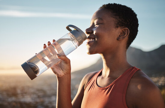 Water, relax and black woman training in nature, happy hiking and fitness progress in Taiwan. Hydration, thirsty and African runner with a drink after sports exercise, running and morning workout