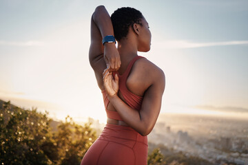 Fitness, black woman and stretching arm on mountain in Cape Town for muscle wellness, healthy goals...