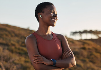 Black woman runner, smile and music with earphones, nature and hill for fitness, happiness and...
