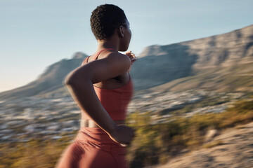 Exercise, fitness and back of black woman running in nature for heart health and wellness. Sports motion blur, training and female runner exercising, jog or cardio workout outdoors with fast speed.