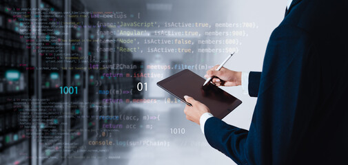 Computer programmer working on big data and computer code in a data center or server room. Data processing, digital technology, and the concept of an internet network.