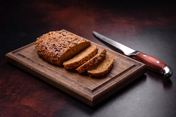 Delicious crispy bread with cereals on a wooden cutting board