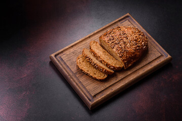 Delicious crispy bread with cereals on a wooden cutting board