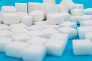 Sugar cubes on blue background