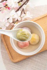 Colored glaze style big tangyuan with cherry blossom flower and syrup soup.