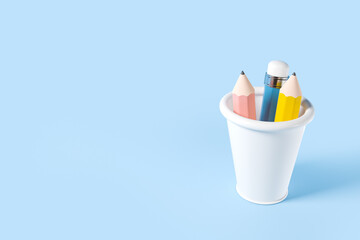 Colorful pencils standing in a cup. Copy space