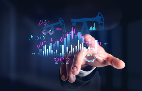 Businessman touching hologram with oil rig and forex chart