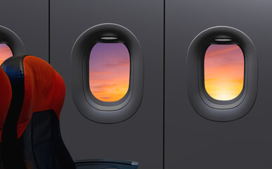 Windows and seats inside airplane while flying on sunrise sky at morning time, View from inside...