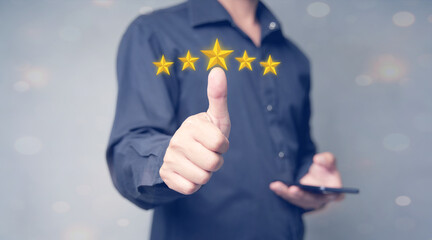 Close up of man customer giving a five star rating on smartphone. Review, Service rating, satisfaction, Customer service experience and satisfaction survey concept