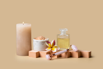 Burning candle, Natural massage oil, frangipani flower and sea salt scrab on beige background for wellness centre or spa cocnept. Modern presentation with geometric form - obrazy, fototapety, plakaty