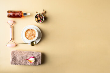 Spa still life composition. Towel with frangipani, gua sha massage roller, essential oil , aromatic bath salt , dryed roses flower.Copy space