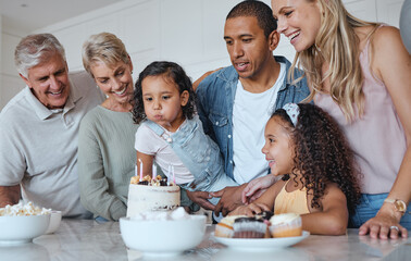 Big family, birthday cake and blowing candles for a wish at home with parents, grandparents and...