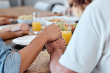 Family, holding hands and praying for Thanksgiving dinner, New Year lunch or Christmas meal in religion routine, tradition and worship. Zoom, bonding man and woman praying for food in house or home