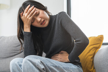 Flatulence asian young woman, girl hand in stomach ache, suffer from food poisoning, abdominal pain...