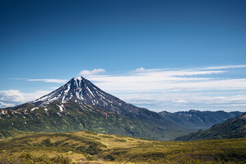 Fototapeta premium Summer landscape. Vilyuchinsky volcano against blue sky. Kamchatka peninsula