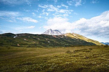 Fototapeta premium Summer landscape. Vilyuchinsky volcano against blue sky. Kamchatka peninsula