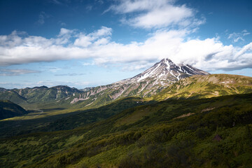 Fototapeta premium Summer landscape. Vilyuchinsky volcano against blue sky. Kamchatka peninsula