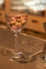 a glass with dry rosebuds